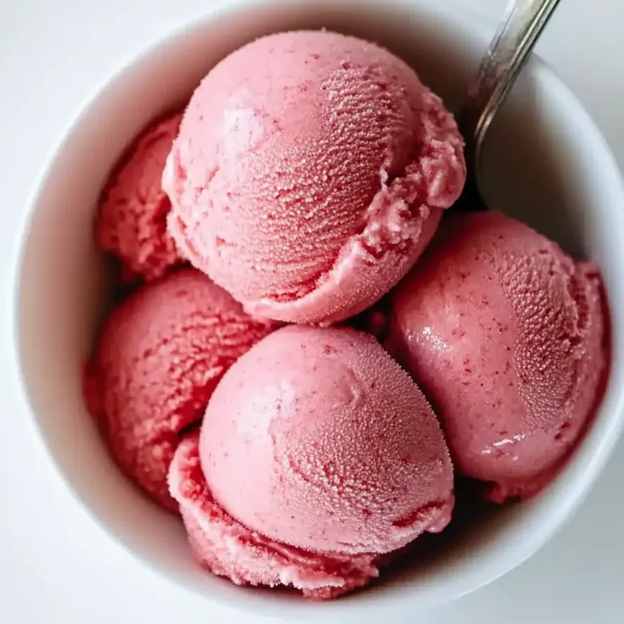 A bowl of fresh and creamy strawberry frozen yogurt.
