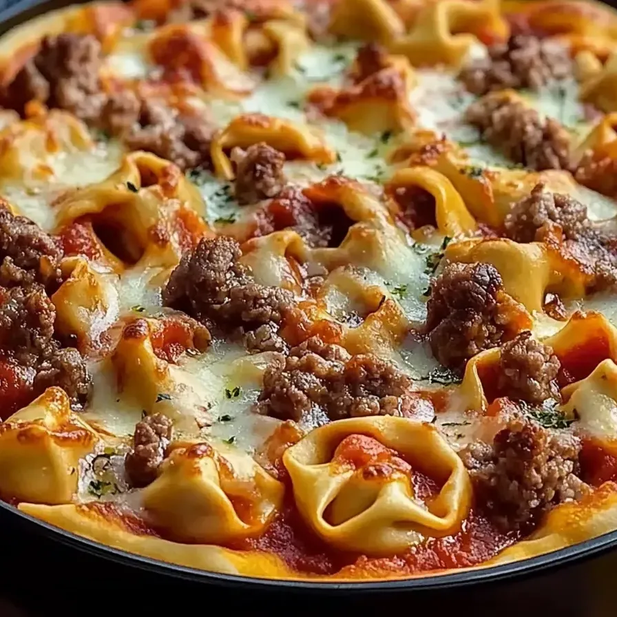 A dish topped with meat and melted cheese.