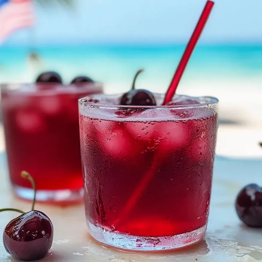 A glass filled with cherry vanilla soda and fizzy bubbles.