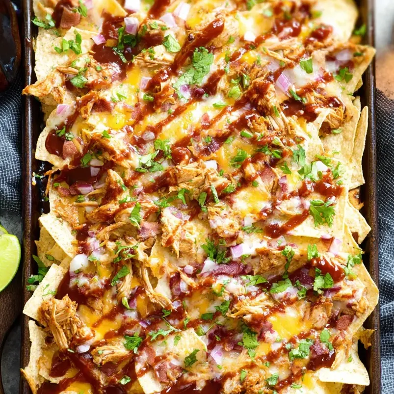 A pan loaded with BBQ chicken nachos fresh out of the oven.