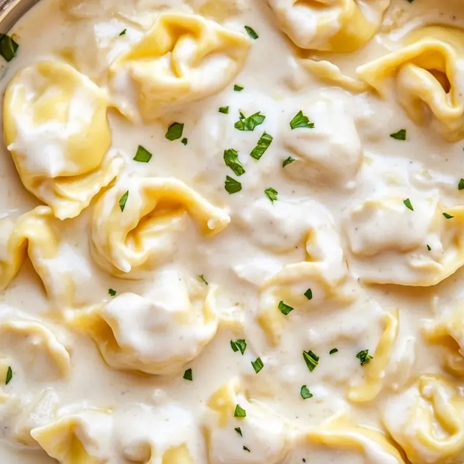 Cheesy garlic parmesan tortellini piled in a bowl.