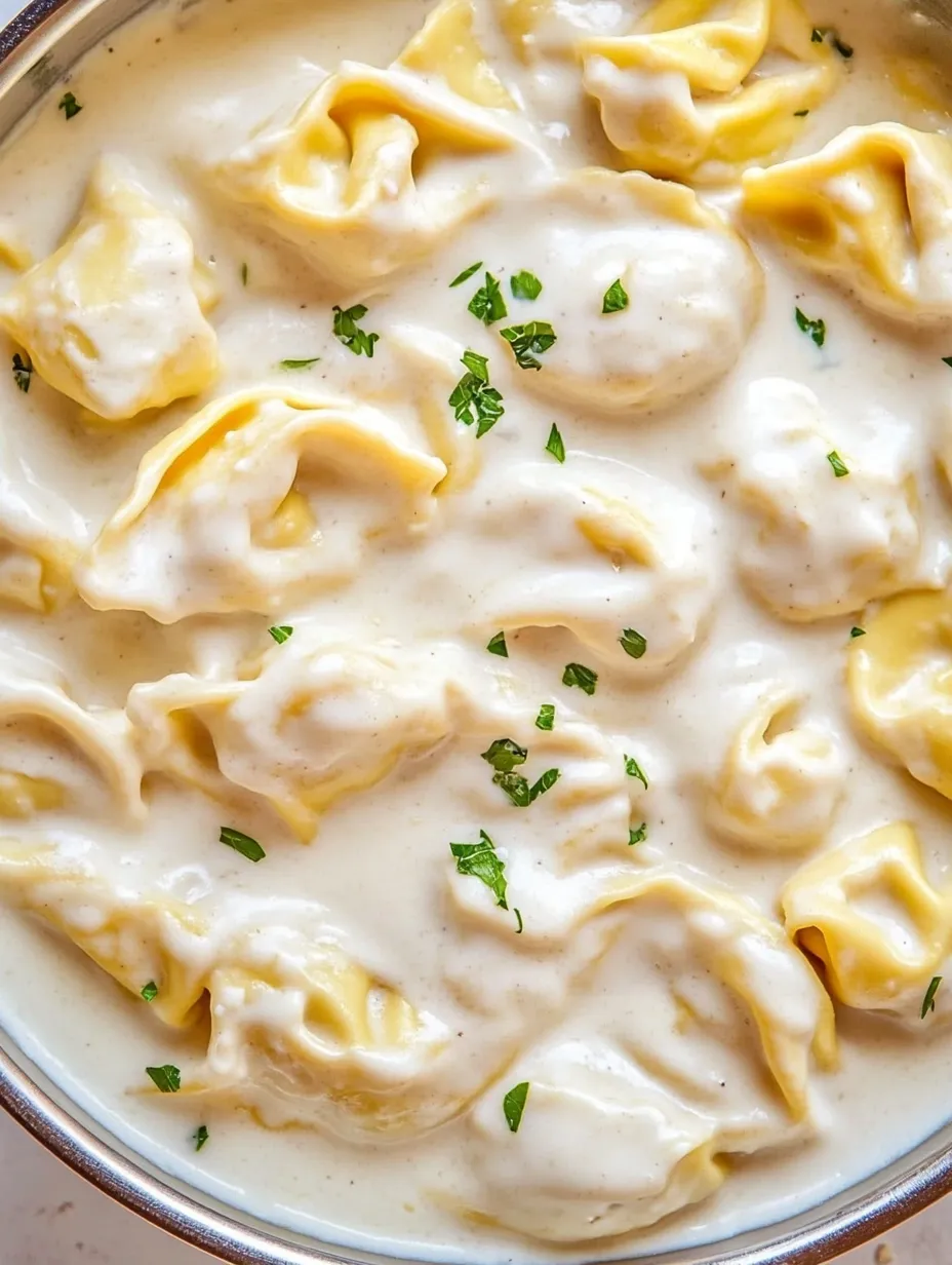 Bowl filled with creamy garlic Parmesan tortellini pasta.