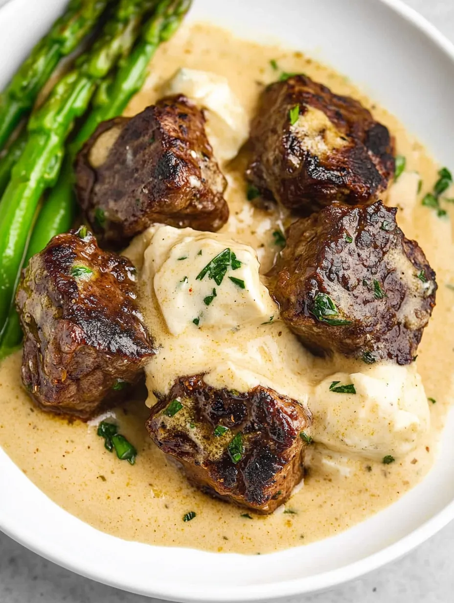 A plate of steak bites with garlic butter.
