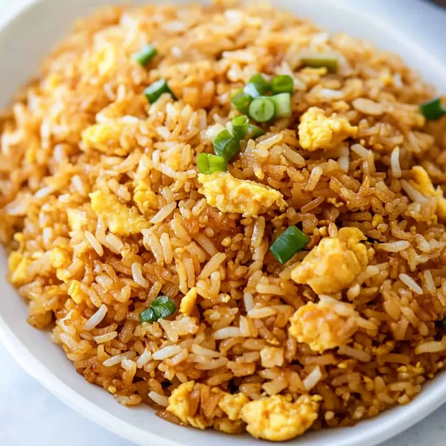 A colorful bowl of rice mixed with scrambled eggs and veggies.