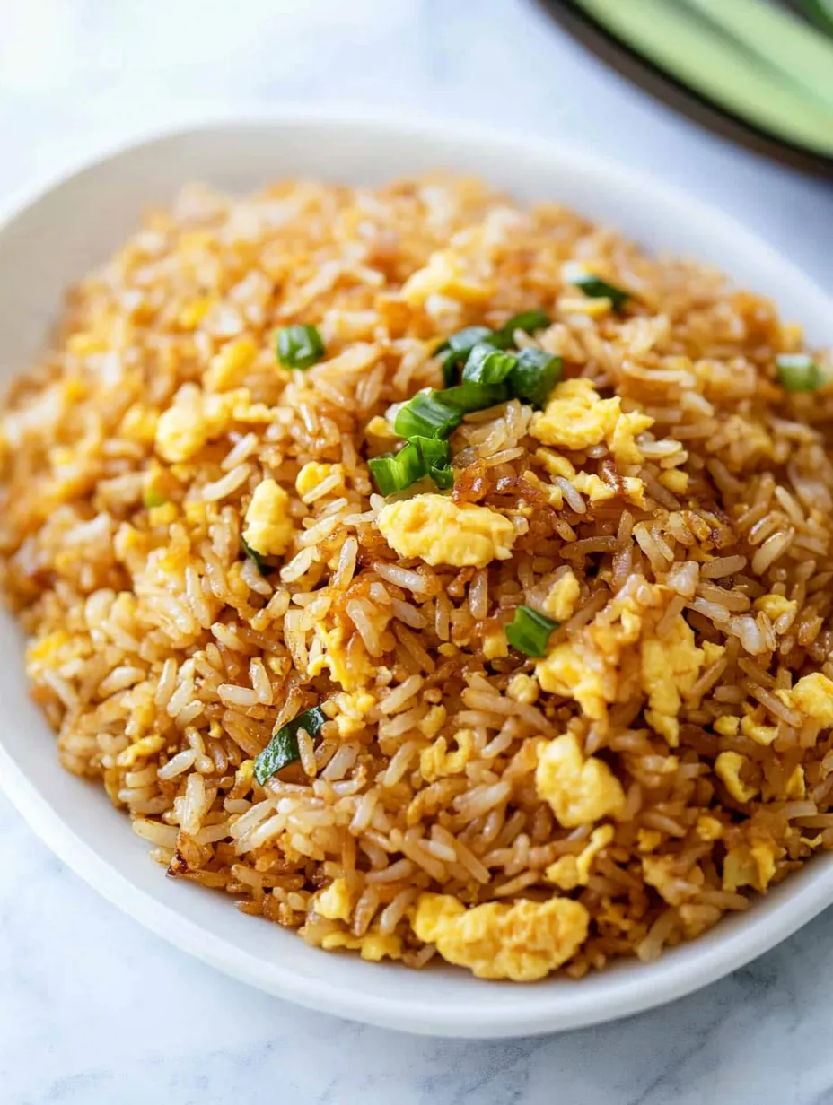 A bowl of rice with eggs and vegetables.