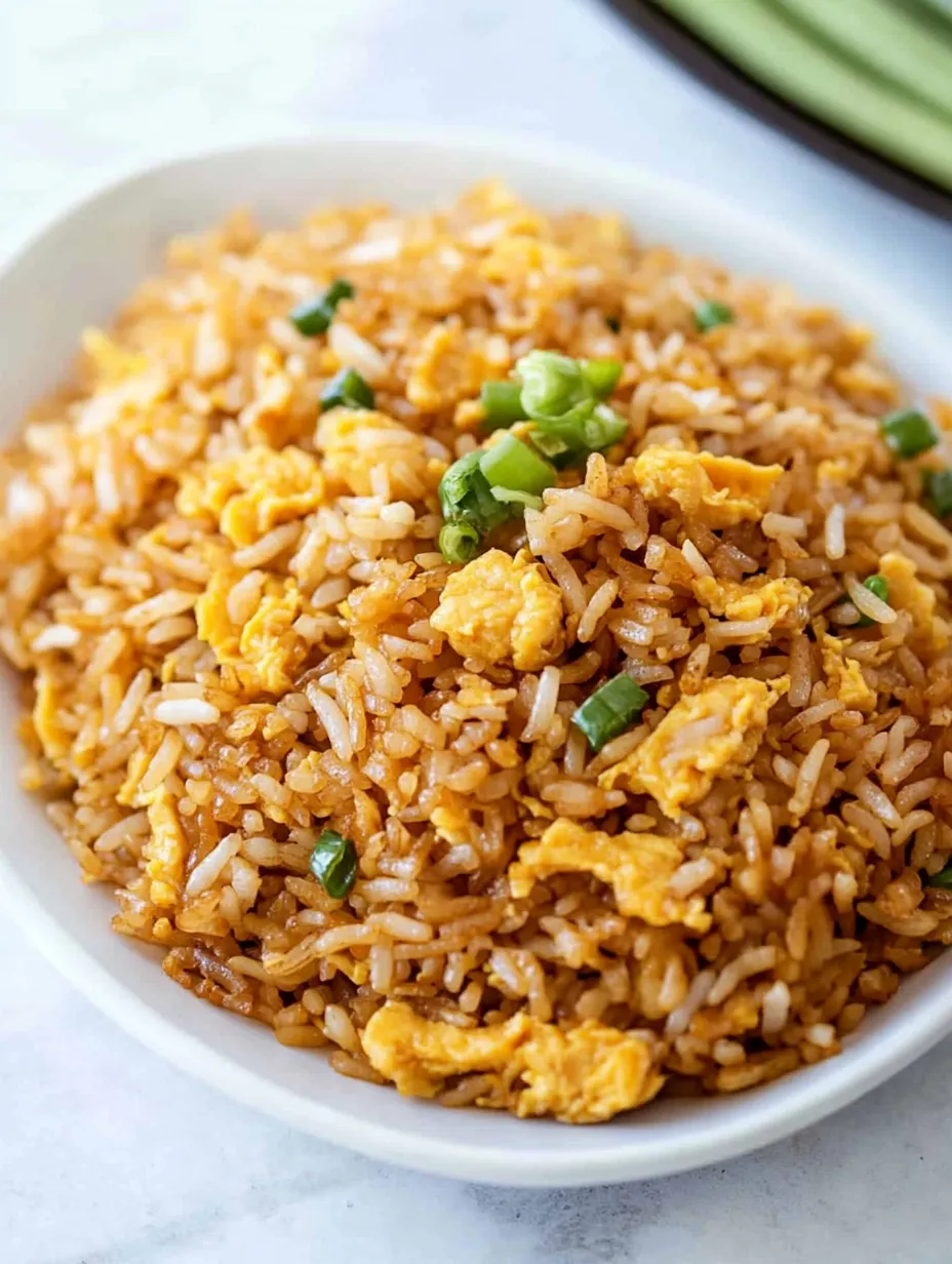 A bowl of rice with vegetables and egg.