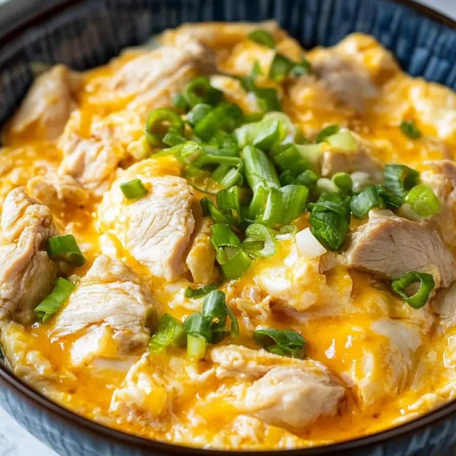 A bowl of chicken and vegetables.