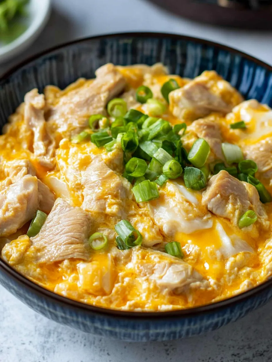 A bowl of oyakodon, a Japanese dish made with chicken and vegetables recipe.