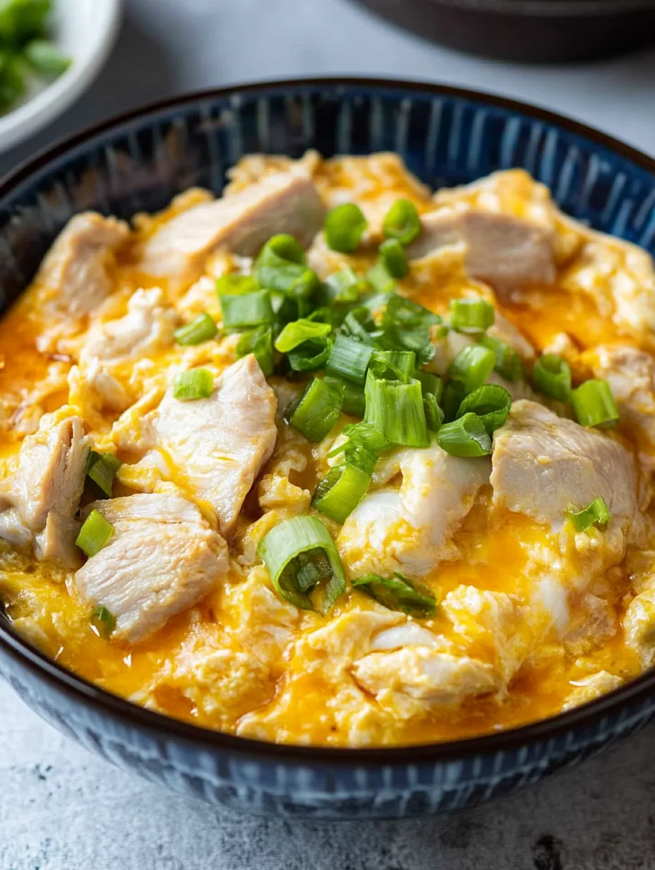 A bowl of oyakodon, a Japanese dish made with chicken and vegetables.