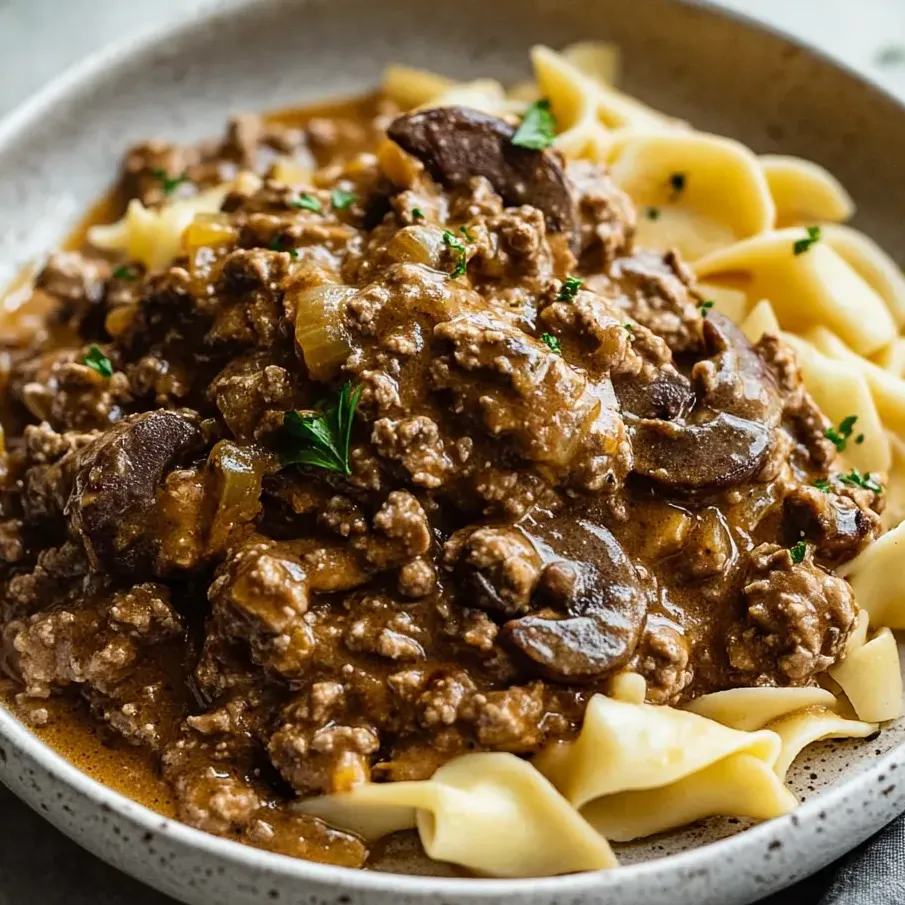A comforting bowl of creamy hamburger stroganoff served warm.