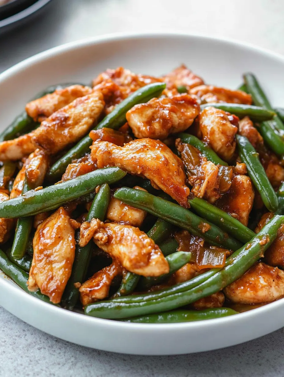 A plate of chicken with green beans recipe.