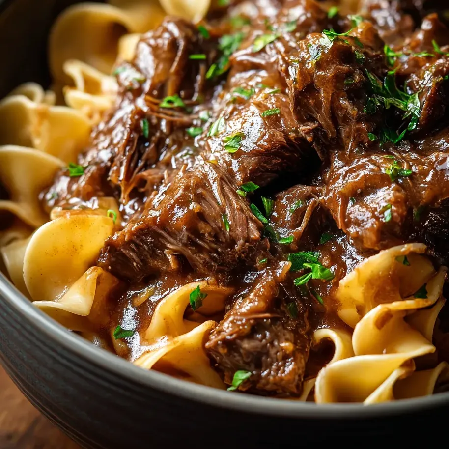 Pasta bowl filled with saucy beef.
