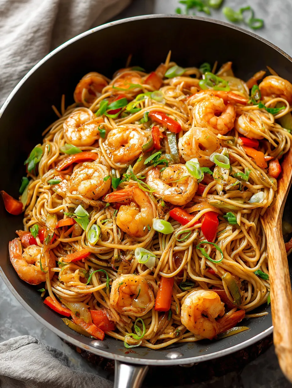 A bowl filled with shrimp and colorful veggies.