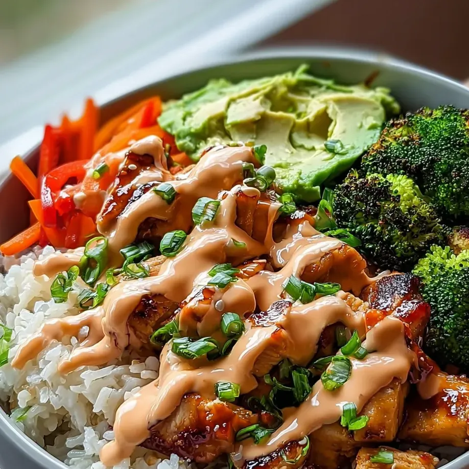 A bowl loaded with rice, greens, carrots, and other veggies.