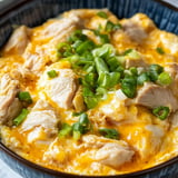 A bowl of chicken and vegetables.