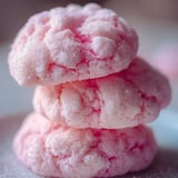 Plate stacked high with pink frosted cookies.