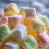 Lots of pastel-colored butter mints on a plate.